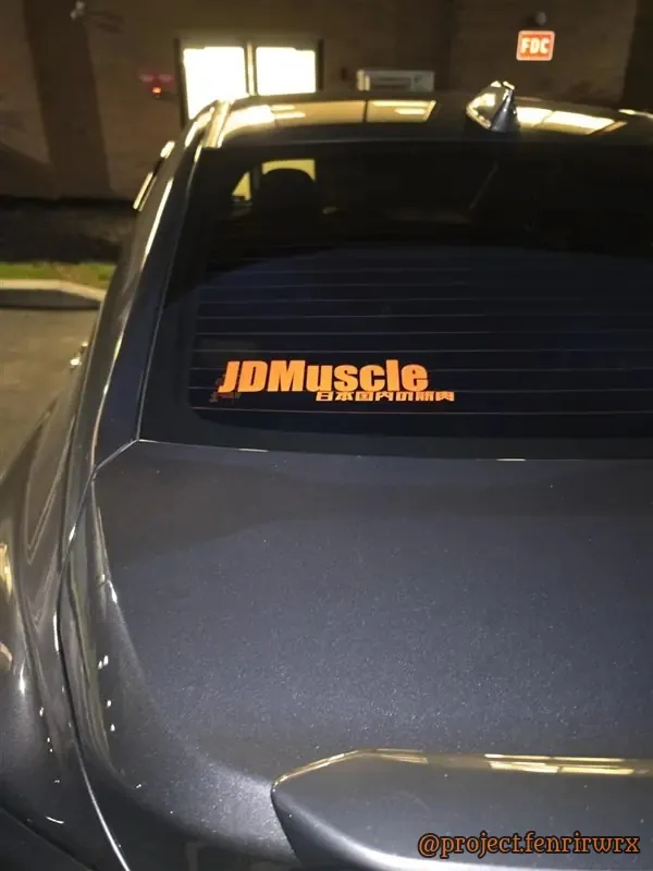 Orange JDMuscle decal on the rear window