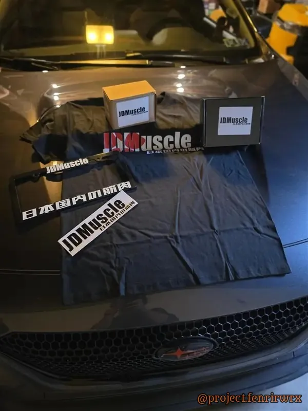JDMuscle merch laid out on the hood