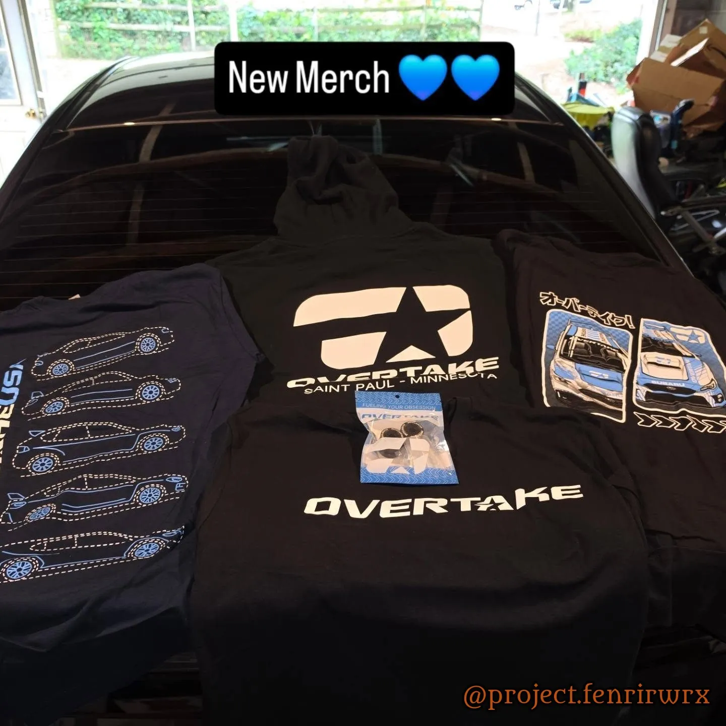 New Overtake merch laid out on the car