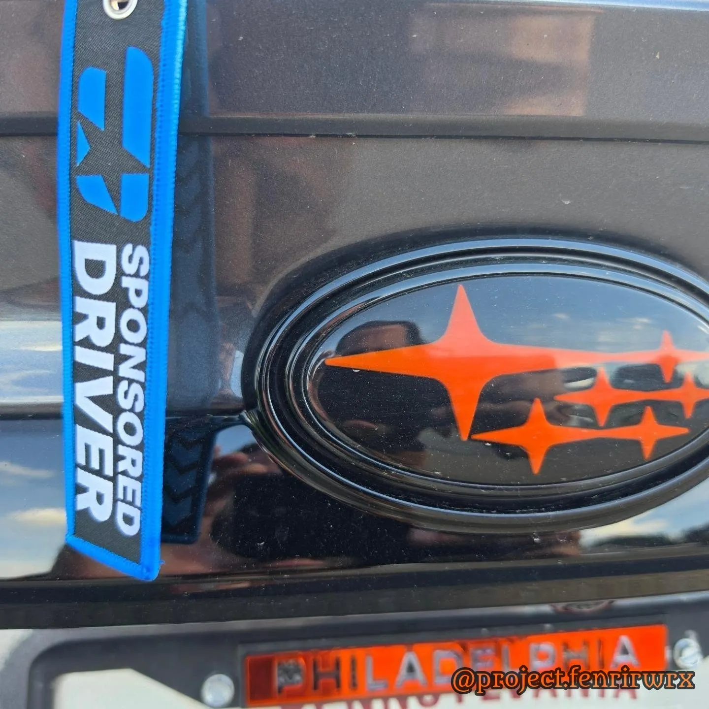 Sponsored driver tag beside the orange badge