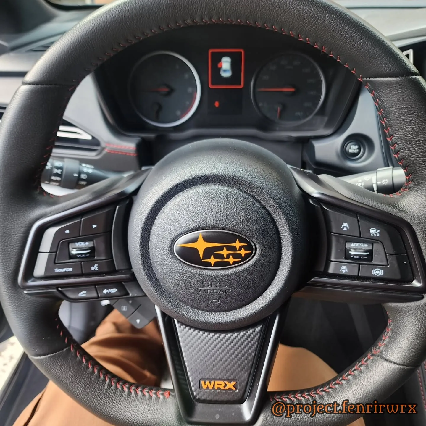 Orange steering wheel badge