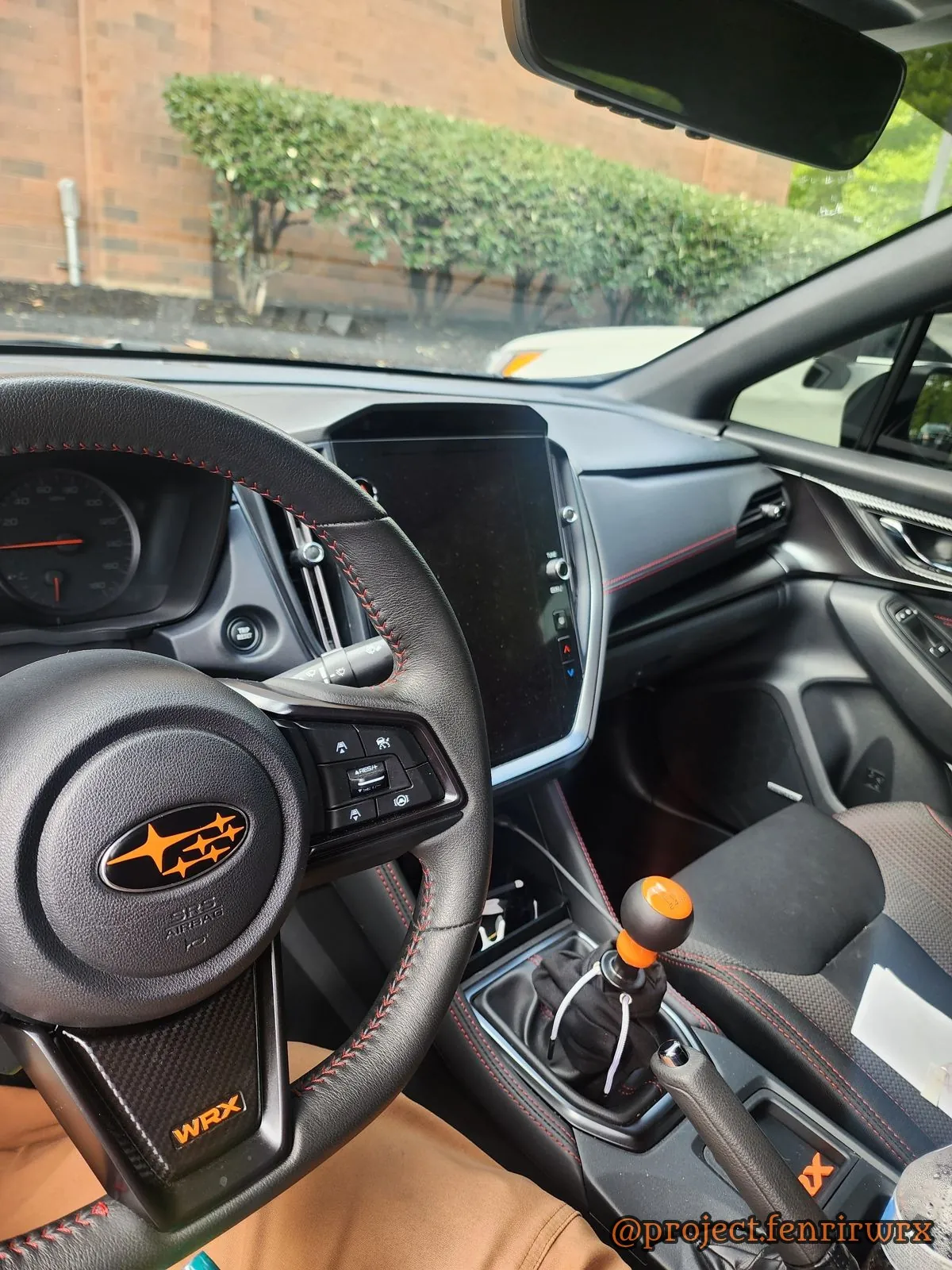 Cockpit with orange wheel badge and shift knob