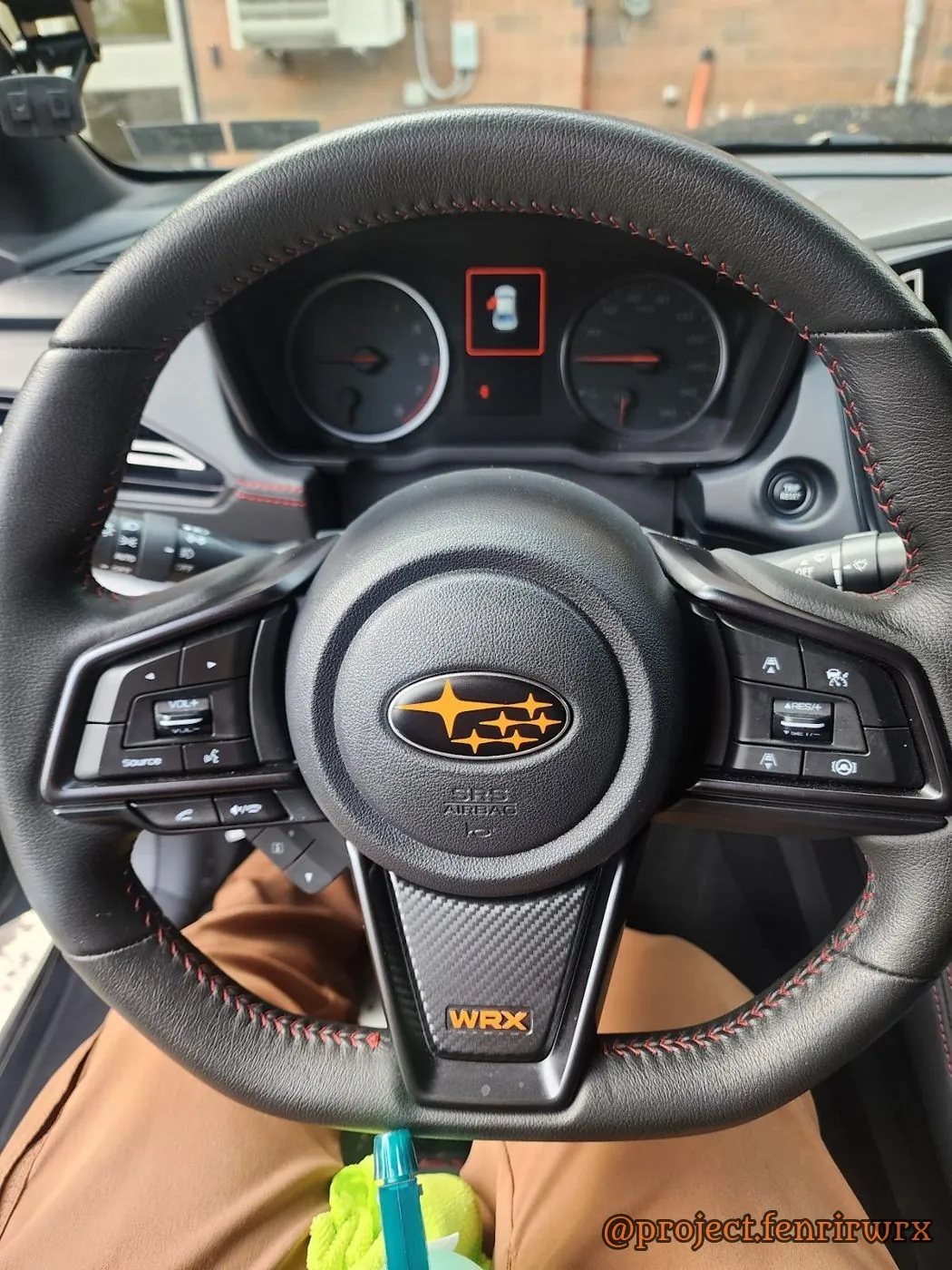 Orange stars and WRX lettering on the wheel