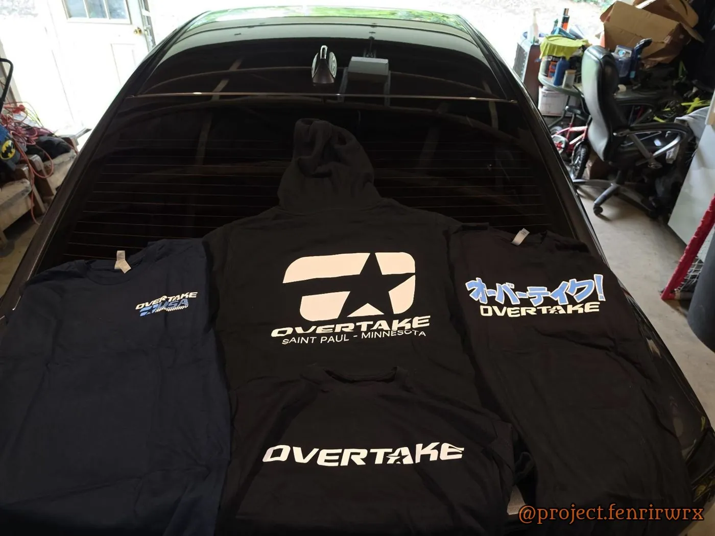 Overtake merch spread on the trunk
