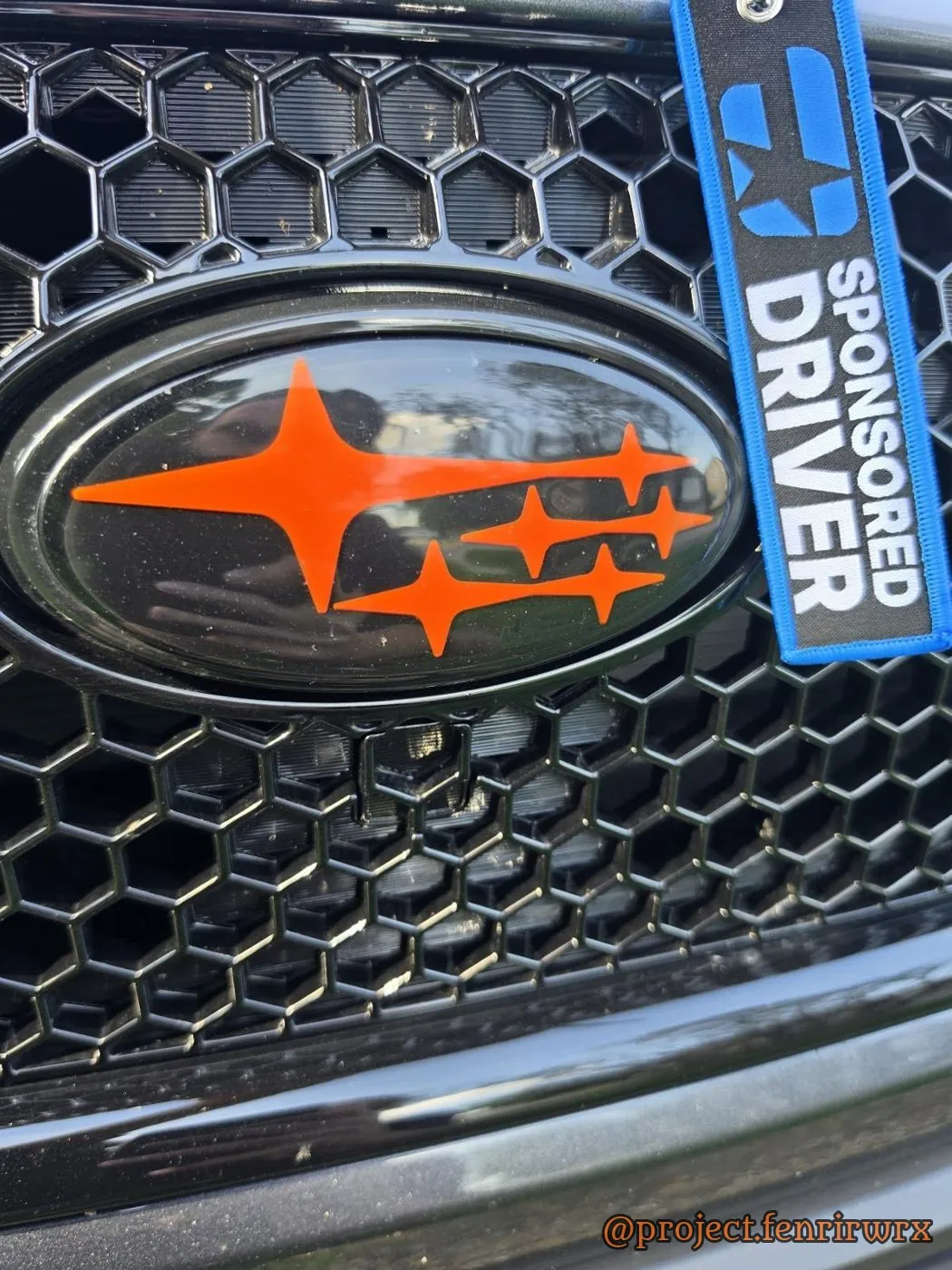 Orange badge with the Sponsored Driver tag